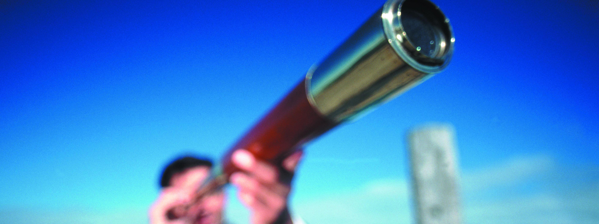 Man looking through a monocular