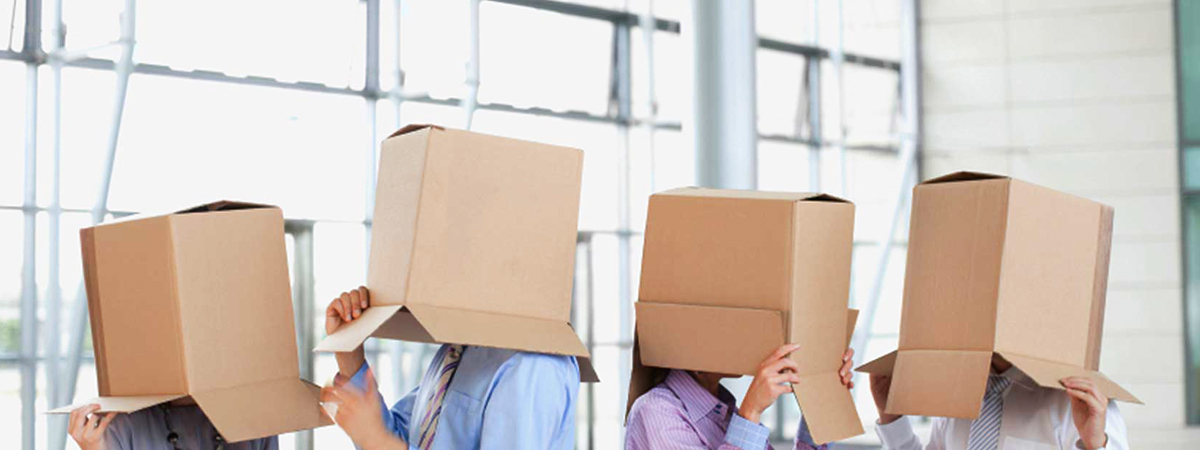 4 people with boxes over their heads