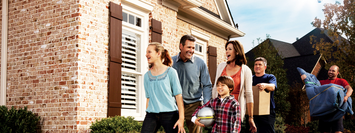 Family and movers arriving at new home