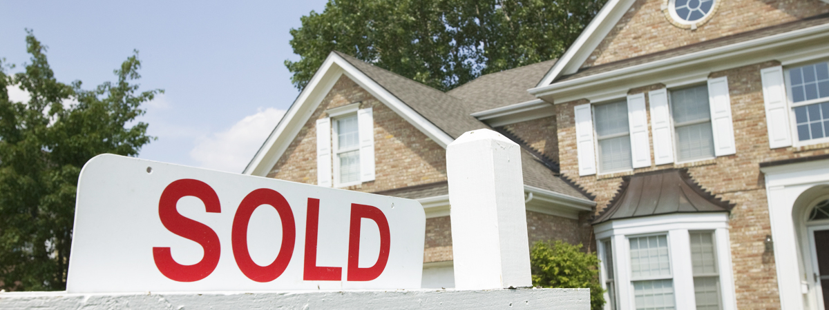 Sold sign in front of house